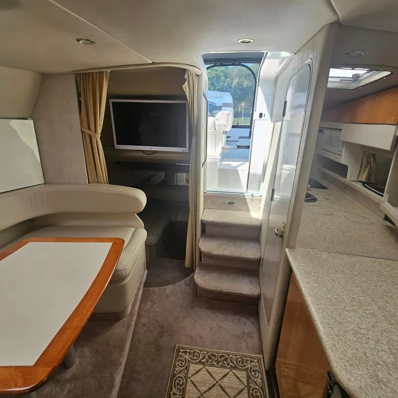 Slide: The Image of Interior of 2000 Formula 31 PC yacht with seating, table, and TV. - 19