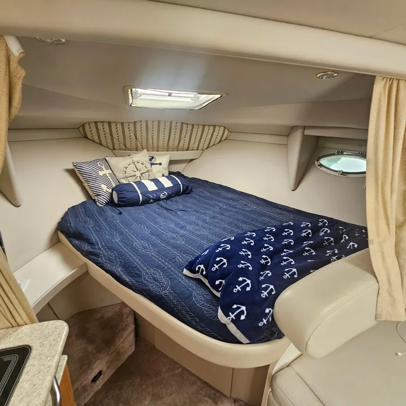 Slide: The Image of Cozy cabin interior of 2000 Formula 31 PC boat with nautical-themed bedding. - 20