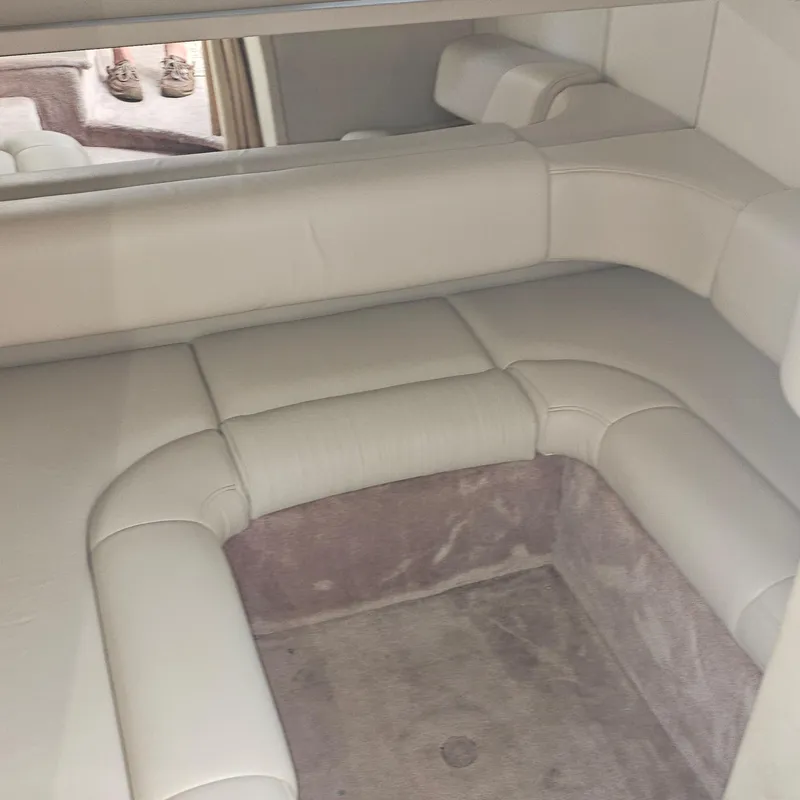 Slide: The Image of Interior of a 2000 Formula 31 PC boat with beige seating and carpeted flooring. - 22