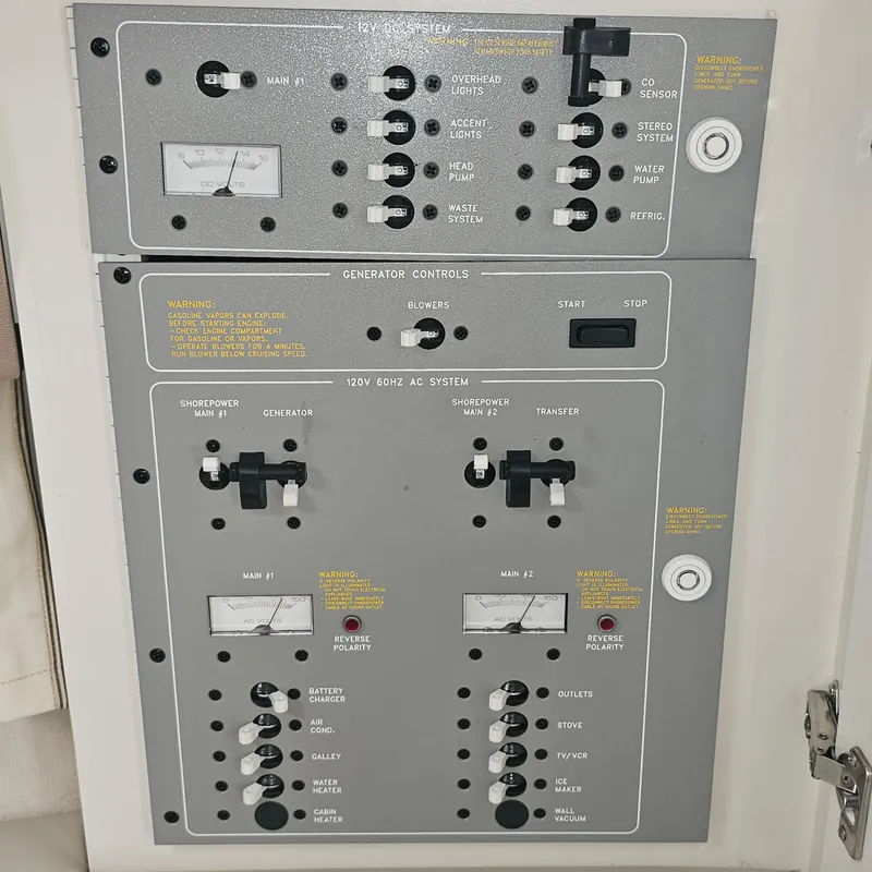 Slide: The Image of Control panel of a 2000 Formula 31 PC boat, featuring various switches and gauges. - 23