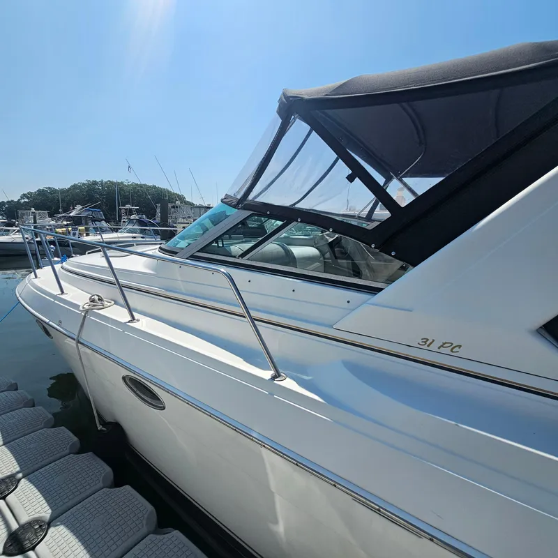Slide: The Image of 2000 Formula 31 PC boat docked at marina under clear blue sky. - 4
