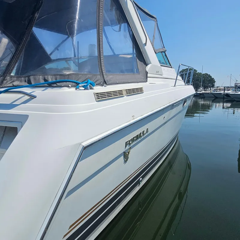Slide: The Image of 2000 Formula 31 PC boat docked in calm marina waters. - 6