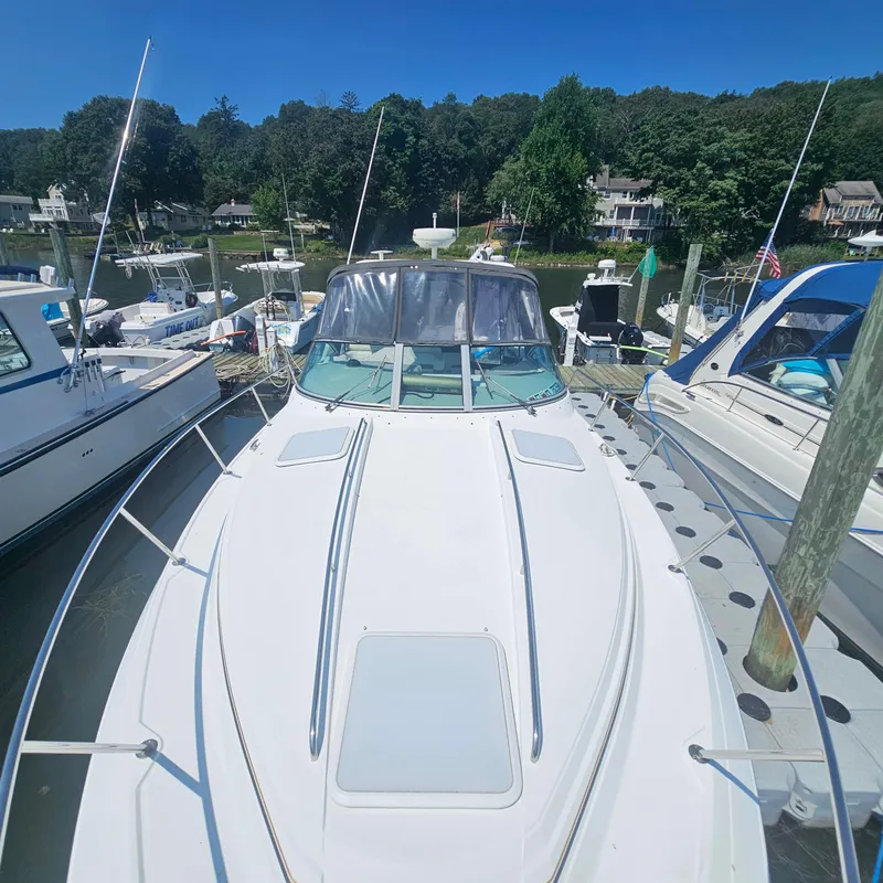 Slide: The Image of 2000 Formula 31 PC boat docked at marina, surrounded by other boats, under clear blue sky. - 8