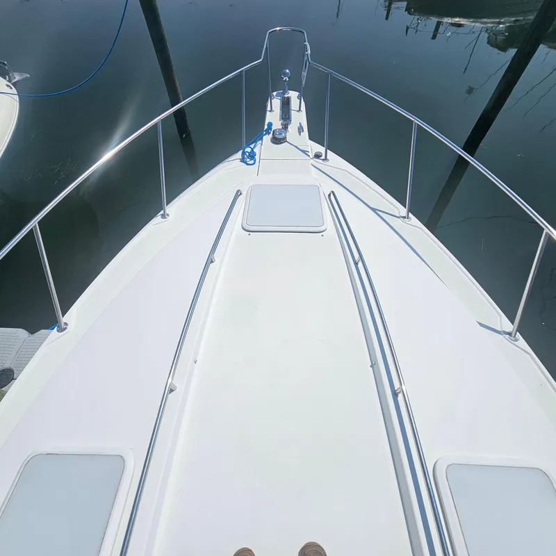 Slide: The Image of Bow view of 2000 Formula 31 PC boat docked on calm water. - 9