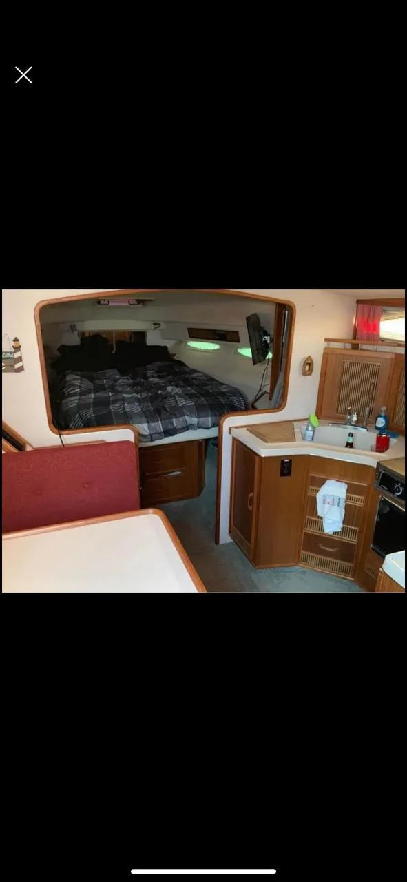 Slide: The Image of Interior of 1987 Sea Ray 36 Sundancer yacht with cozy cabin and kitchenette. - 10
