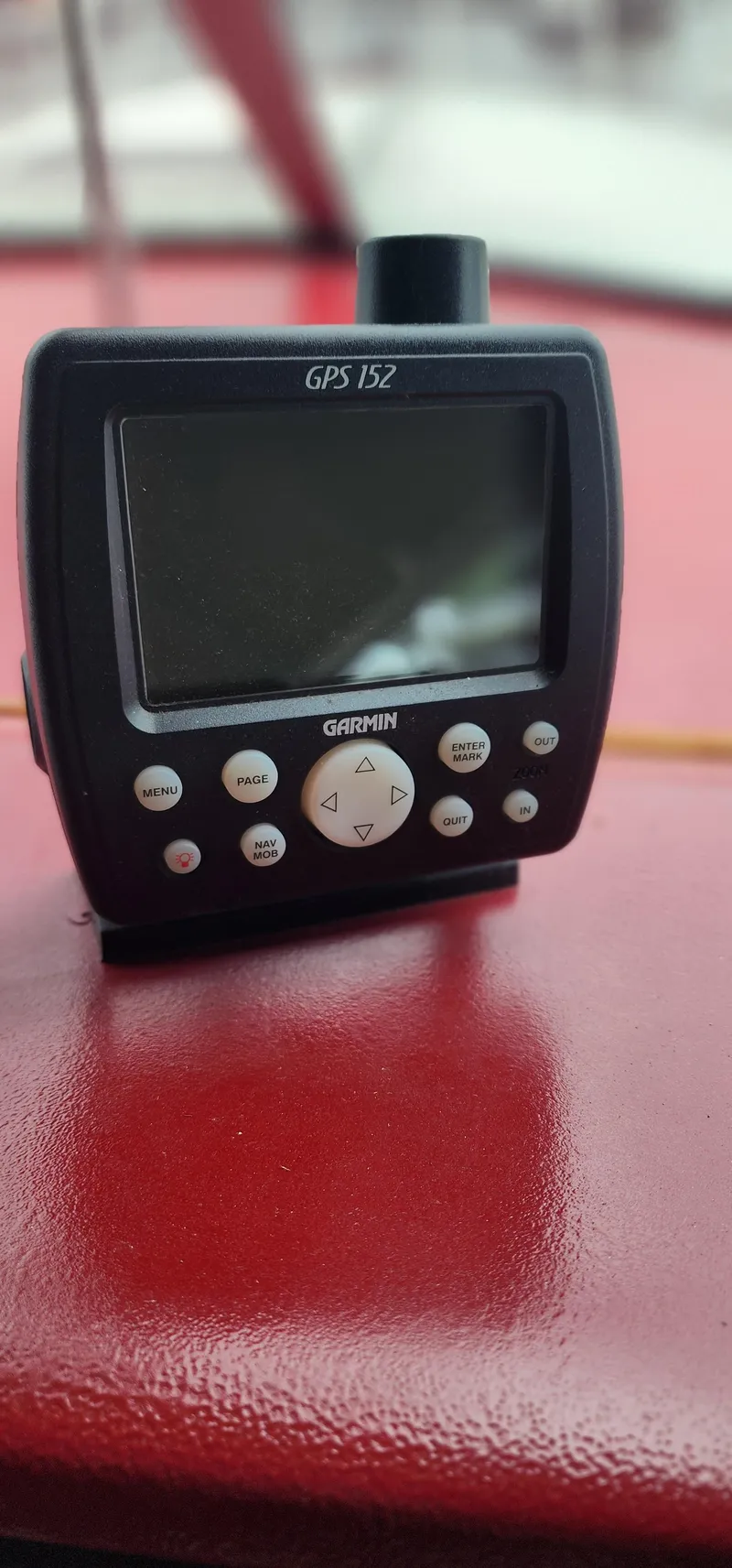 Slide: The Image of Garmin GPS 152 device on a red surface, Sea Ray 36 Sundancer, 1987 model. - 17