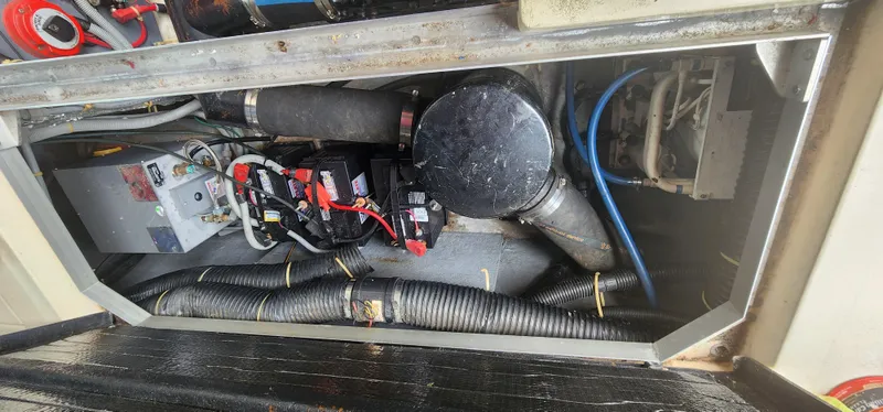 Slide: The Image of Engine compartment of a 1987 Sea Ray 36 Sundancer with visible wiring and components. - 29