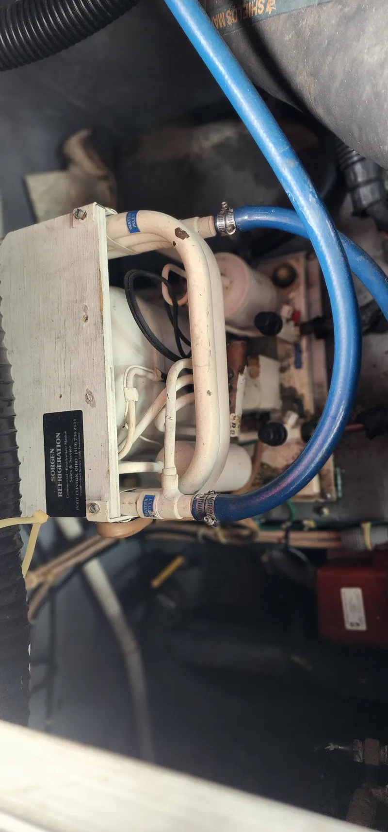 Slide: The Image of Engine compartment of 1987 Sea Ray 36 Sundancer with visible hoses and components. - 31