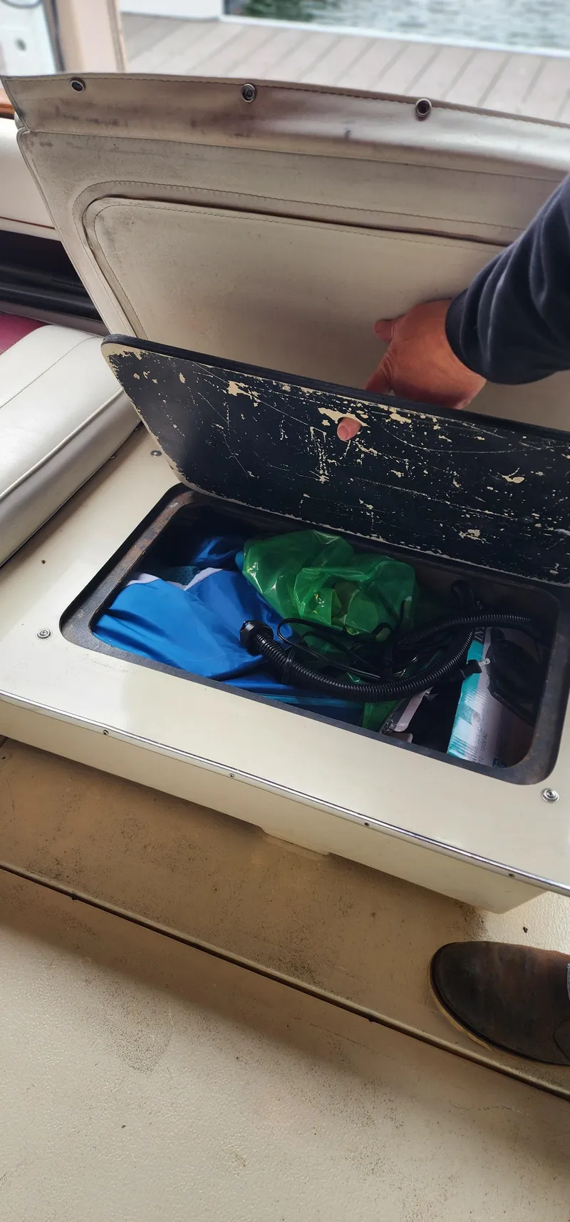 Slide: The Image of Storage compartment on a 1987 Sea Ray 36 Sundancer boat, containing various items. - 32