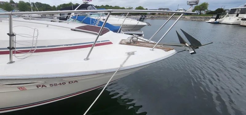 Slide: The Image of 1987 Sea Ray 36 Sundancer docked, featuring anchor and registration number PA 5840 DA. - 37