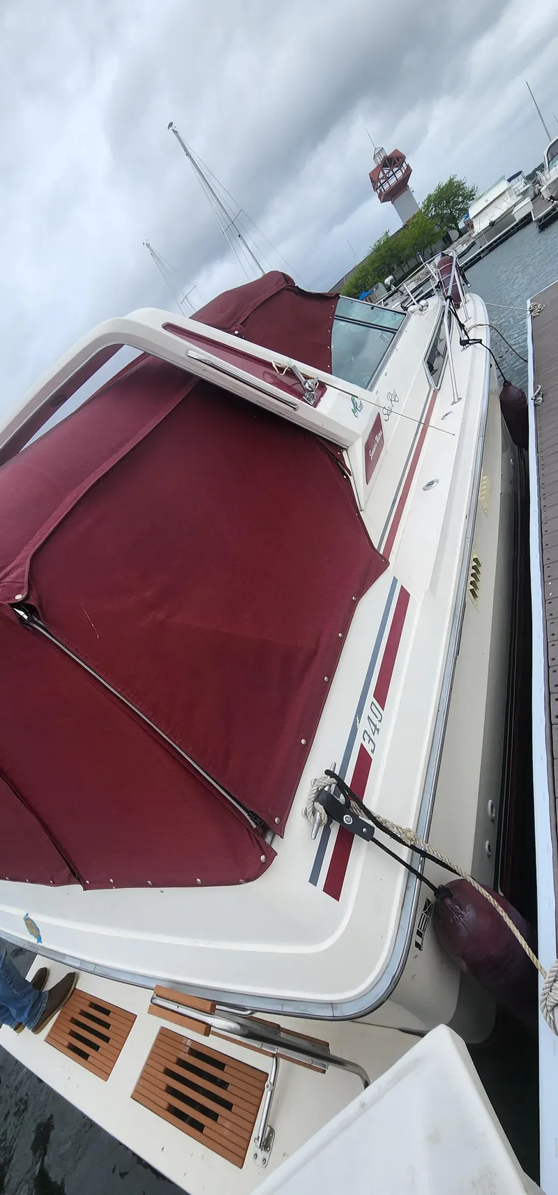 Slide: The Image of 1987 Sea Ray 36 Sundancer docked with maroon canopy, overcast sky. - 39