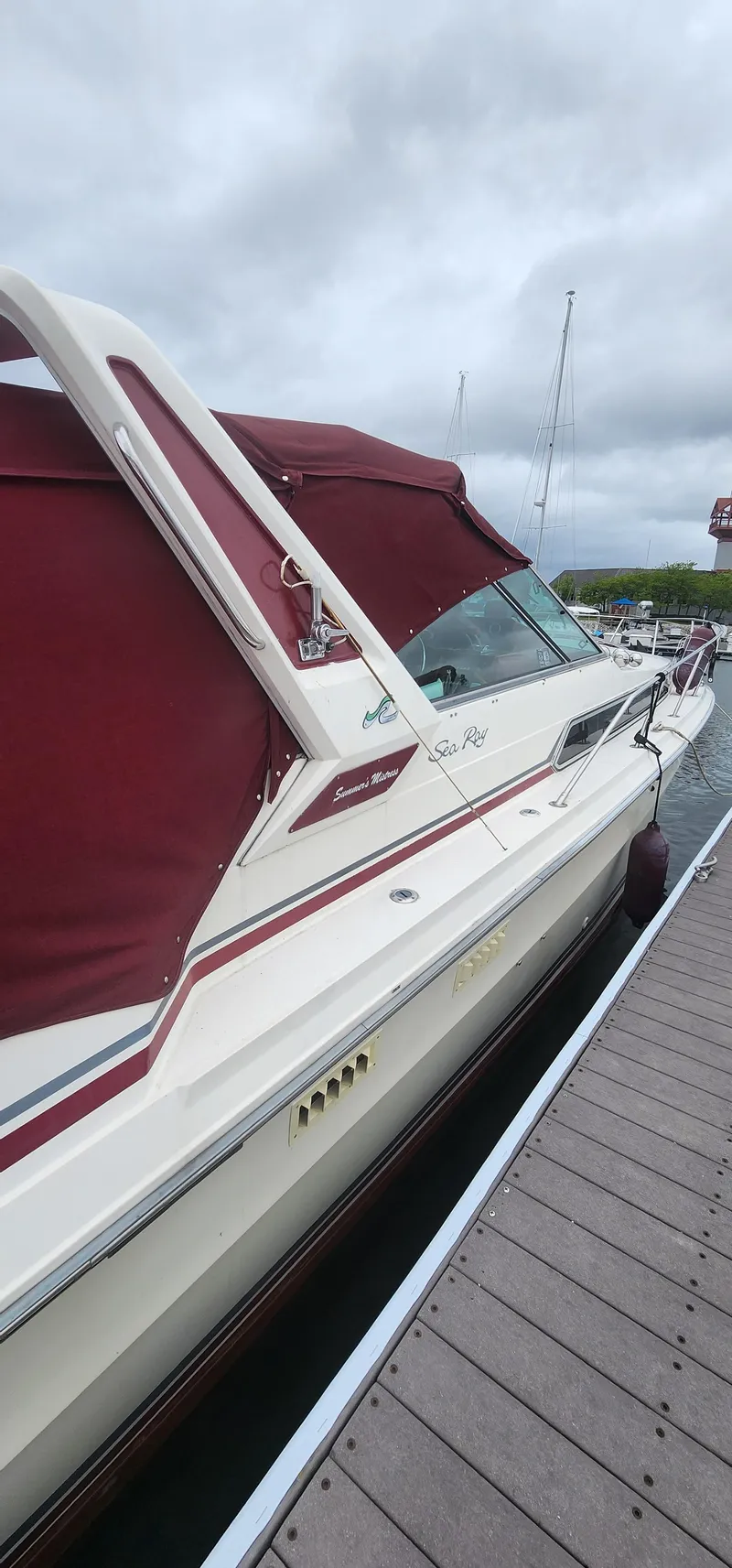 Slide: The Image of 1987 Sea Ray 36 Sundancer docked with maroon canopy, overcast sky. - 41