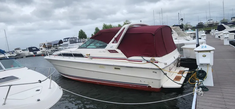Slide: The Image of 1987 Sea Ray 36 Sundancer docked at marina with maroon canopy. - 43