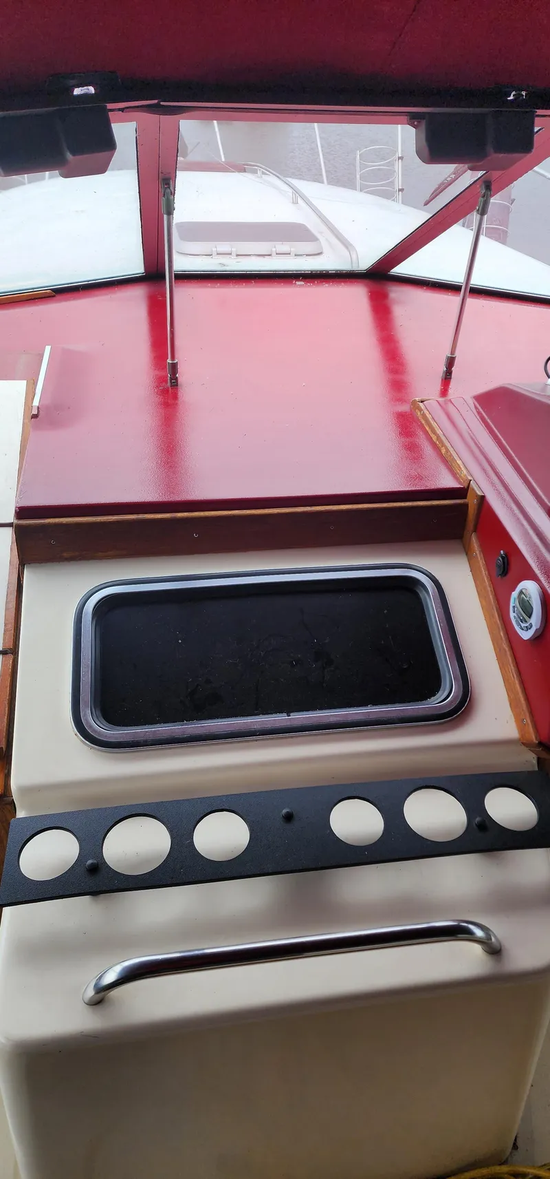 Slide: The Image of 1987 Sea Ray 36 Sundancer helm with red dashboard and control panel. - 7