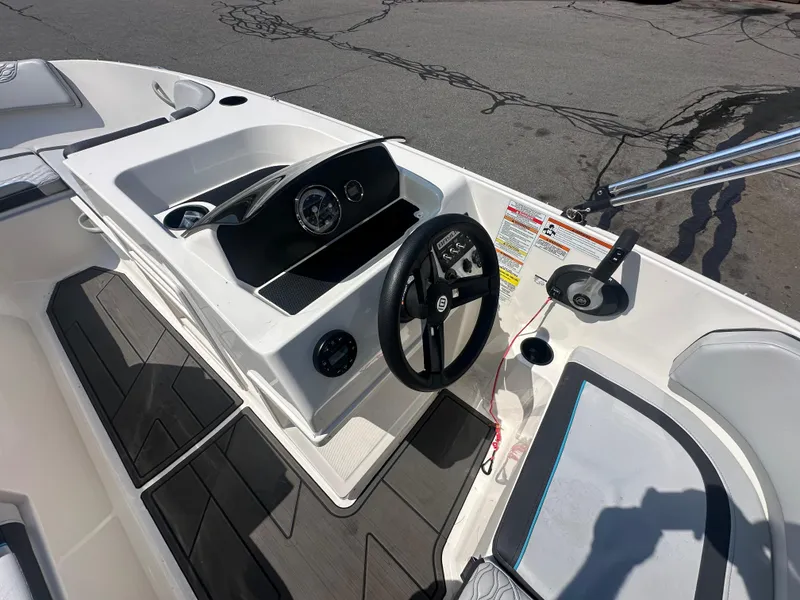 Slide: The Image of 2022 Bayliner Element M17 boat cockpit with steering wheel and dashboard controls. - 11