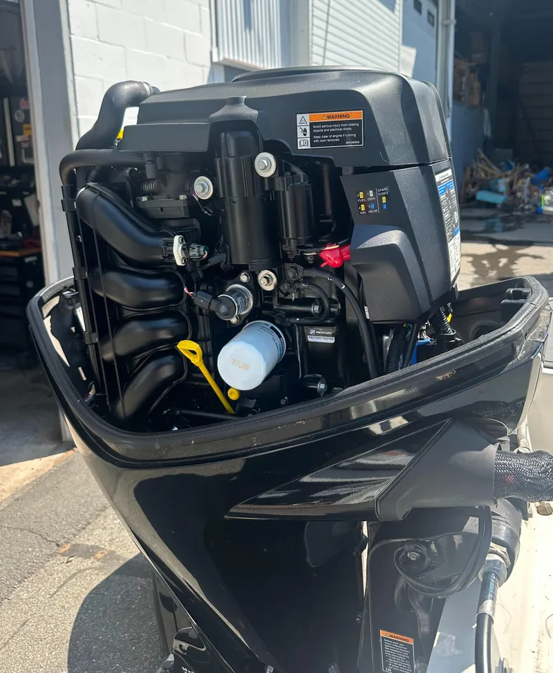 Slide: The Image of 2022 Bayliner Element M17 outboard motor, detailed view in a workshop setting. - 15