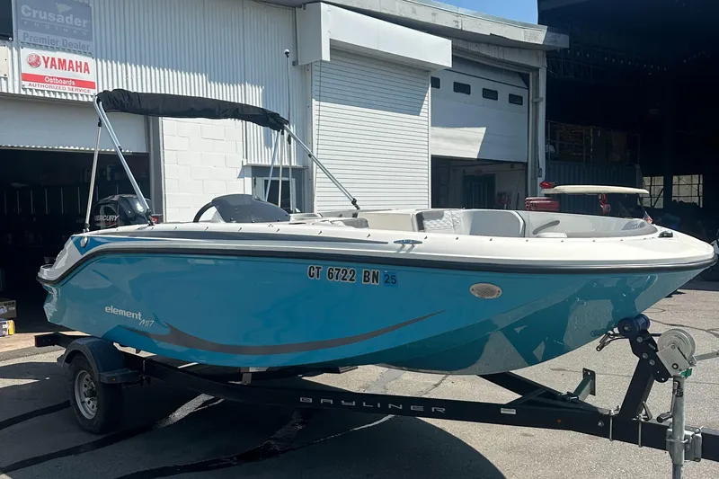 Slide: The Image of 2022 Bayliner Element M17 boat on trailer outside dealership. - 2
