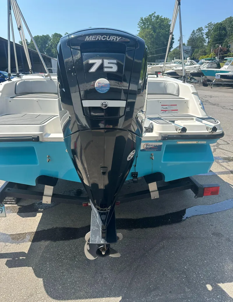 Slide: The Image of 2022 Bayliner Element M17 with Mercury 75 outboard motor, parked on a trailer. - 6