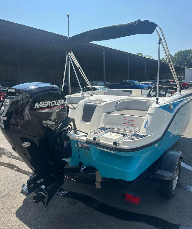 Slide: The Image of 2022 Bayliner Element M17 boat with Mercury 75 engine, parked in a marina. - 7
