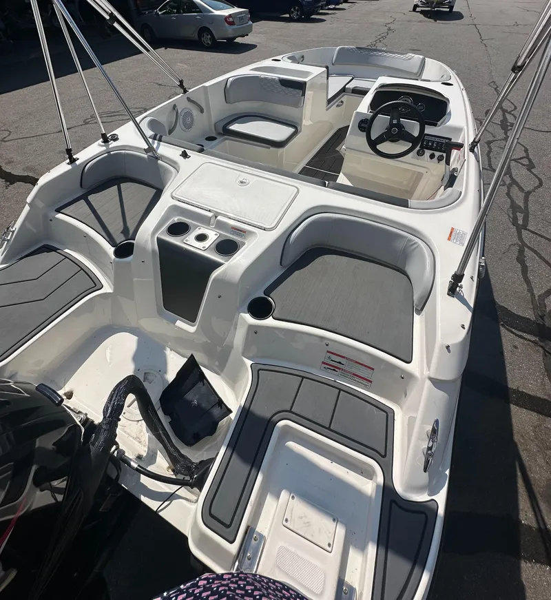 Slide: The Image of 2022 Bayliner Element M17 boat interior with seating and steering wheel. - 8