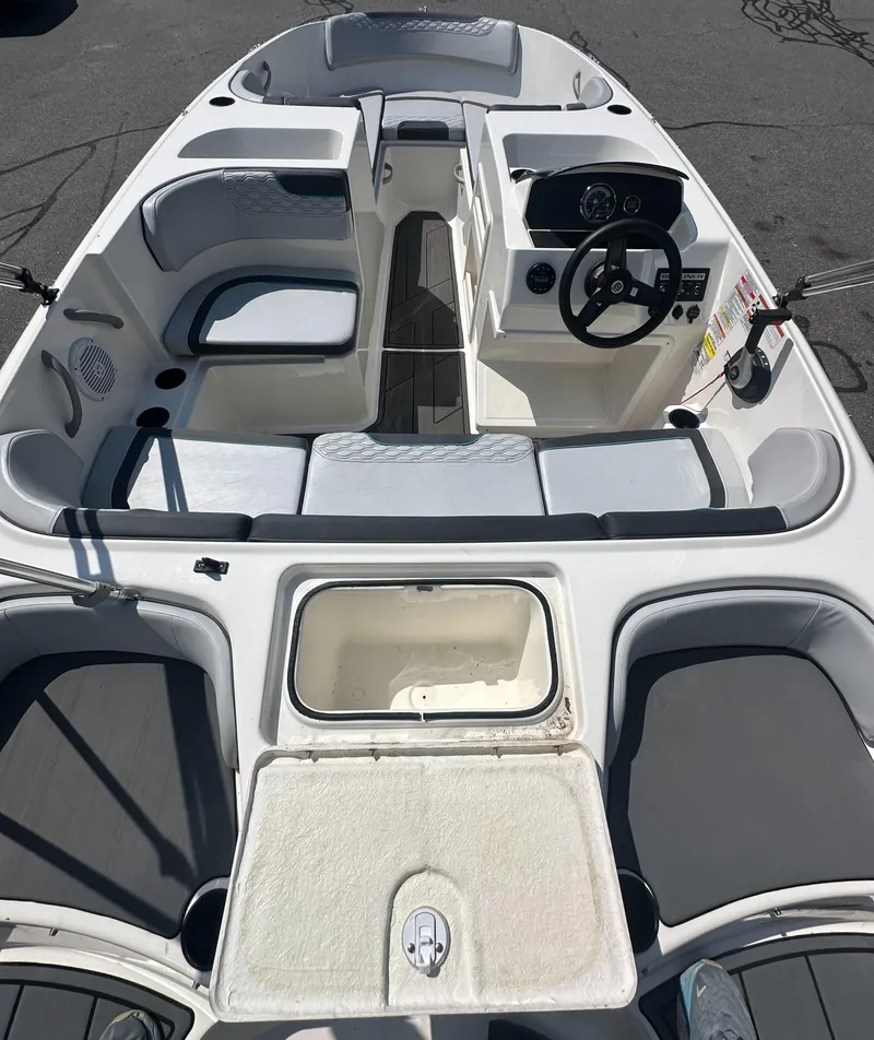 Slide: The Image of 2022 Bayliner Element M17 boat interior with seating and steering console. - 9
