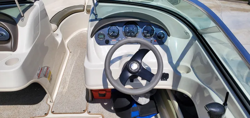 Slide: The Image of 2005 Sea Ray 200 Sport boat dashboard with steering wheel and instrument panel. - 10