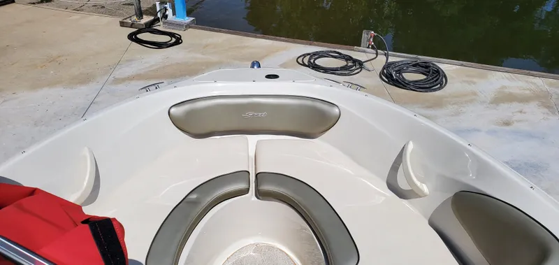 Slide: The Image of Bow seating area of a 2005 Sea Ray 200 Sport boat at dockside. - 12