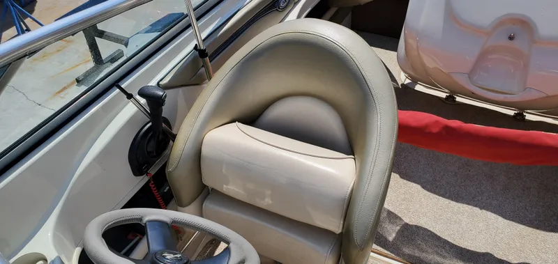 Slide: The Image of 2005 Sea Ray 200 Sport boat interior with steering wheel and seating. - 15