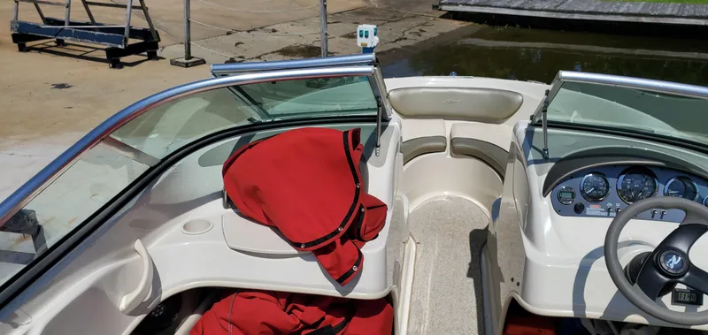 Slide: The Image of 2005 Sea Ray 200 Sport boat interior with red life jackets and dashboard controls. - 16