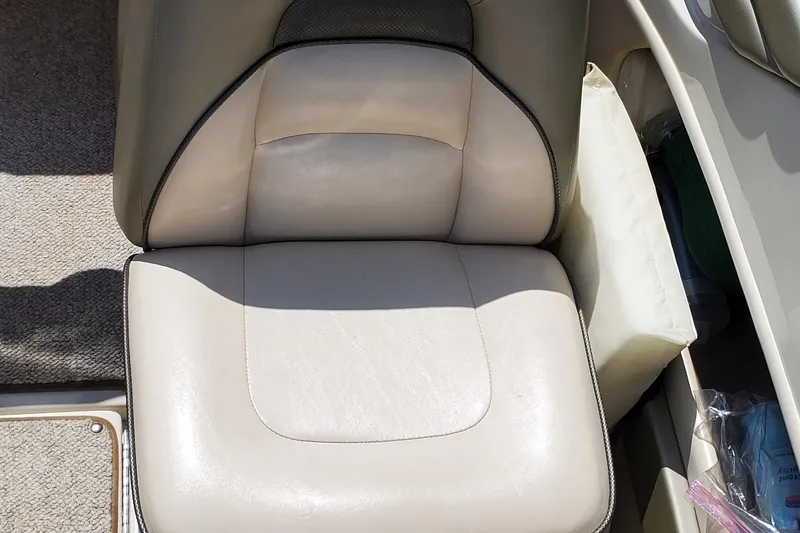 Slide: The Image of Boat seat of a 2005 Sea Ray 200 Sport, featuring beige upholstery. - 20