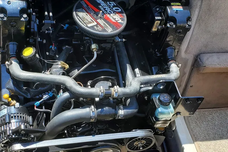 Slide: The Image of Engine of a 2005 Sea Ray 200 Sport boat, showcasing detailed components and hoses. - 21