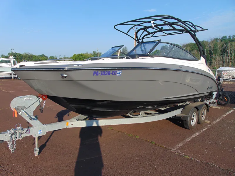 The Image of 2019 Yamaha Boats 242 Limited S E-Series on trailer, parked outdoors. - 1