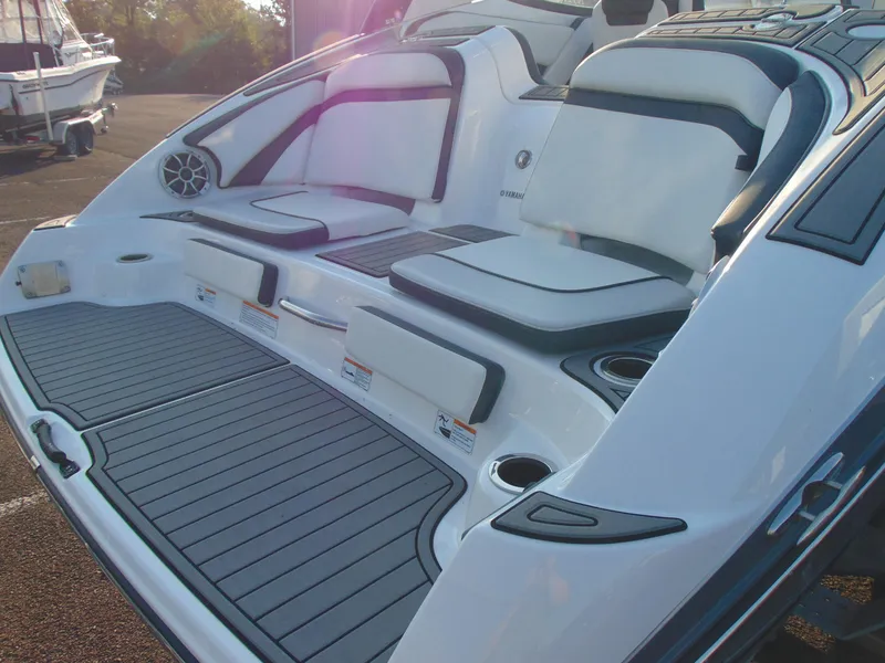 Slide: The Image of 2019 Yamaha Boats 242 Limited S E-Series, rear seating and deck area, sunlight reflection. - 4