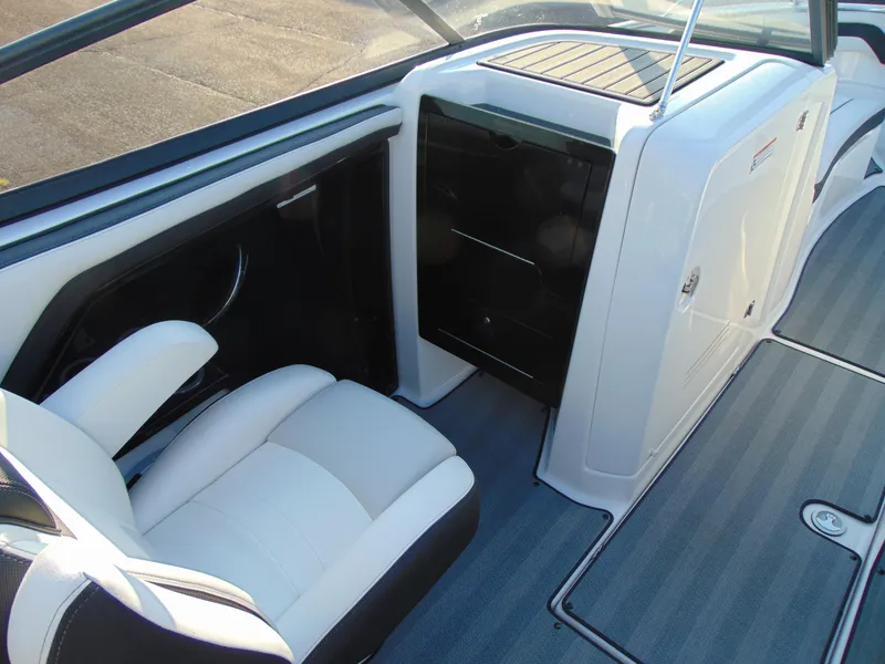 Slide: The Image of 2019 Yamaha Boats 242 Limited S E-Series interior with white seating and storage compartments. - 8