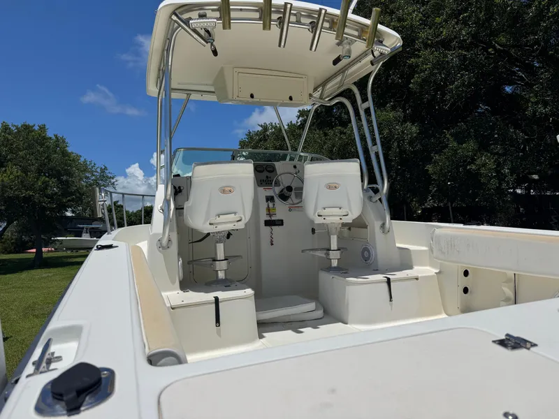 Slide: The Image of 2006 Hydrosport 23wa boat interior with seating and steering wheel, under a clear blue sky. - 10