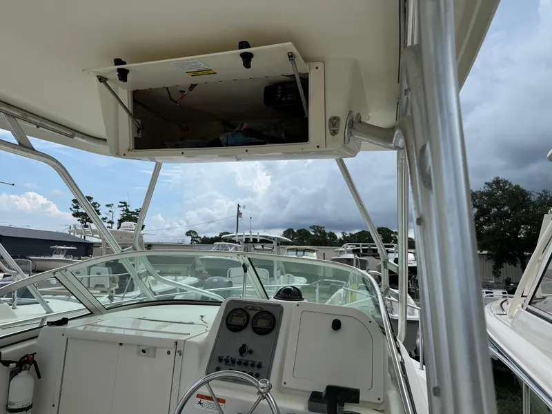 Slide: The Image of 2006 Hydrosport 23wa boat interior with open storage compartment and steering console. - 4