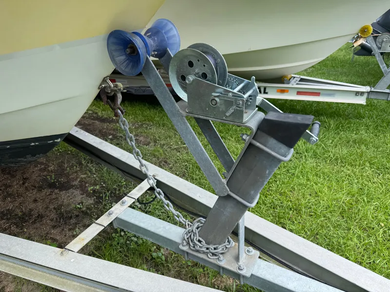 Slide: The Image of Trailer hitch and winch securing a 2006 Hydrosport 23wa boat on grass. - 7