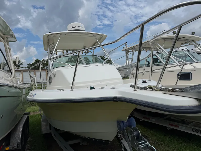Slide: The Image of 2006 Hydrosport 23wa boat with Garmin equipment, docked under a cloudy sky. - 8