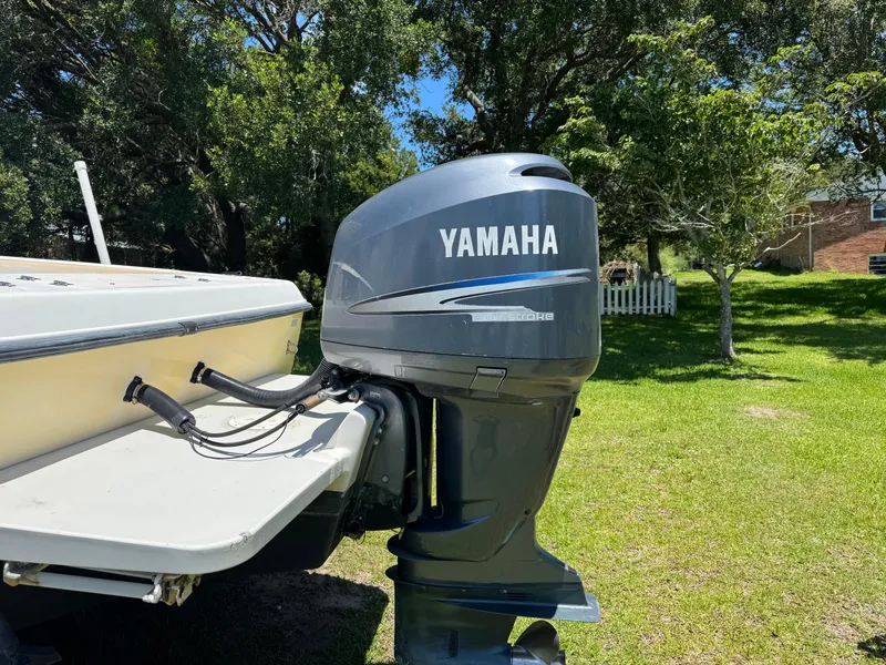 Slide: The Image of 2006 Hydrosport 23wa boat with Yamaha outboard motor in a grassy yard. - 9