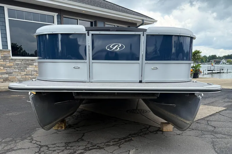 Slide: The Image of 2022 Bentley Pontoons 220CR boat on display, front view, blue and silver design. - 3