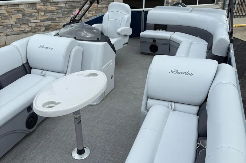 Slide: The Image of 2022 Bentley Pontoons 220CR interior with plush seating and a small table. - 7