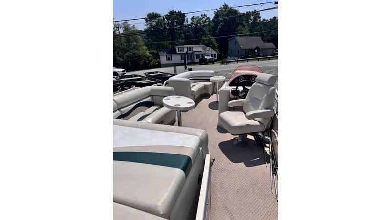 Slide: The Image of 2007 Starcraft Elite 206 RE pontoon boat interior with seating and steering console. - 2