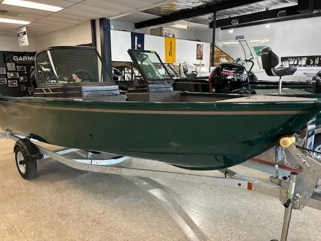 The Image of 2026 Lund 1650 Angler Sport boat in showroom, green exterior, on trailer. - 0