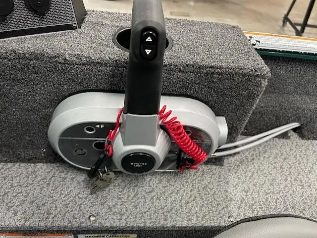 Slide: The Image of Control panel of 2026 Lund 1650 Angler Sport boat with throttle and safety lanyard. - 10