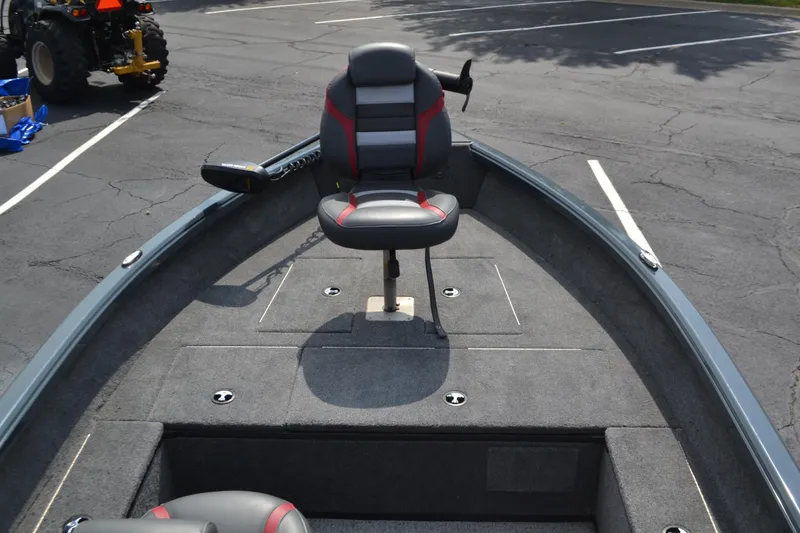 Slide: The Image of 2024 Ranger VS1665T boat with a swivel seat on a carpeted deck in a parking lot. - 3