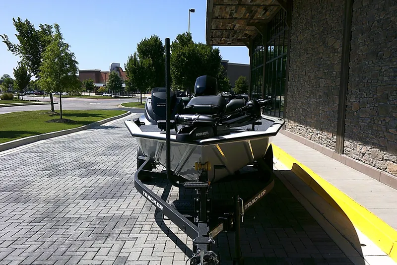 Slide: The Image of 2025 Tracker Pro Team 195 Tournament Edition boat on a trailer, parked outdoors. - 3