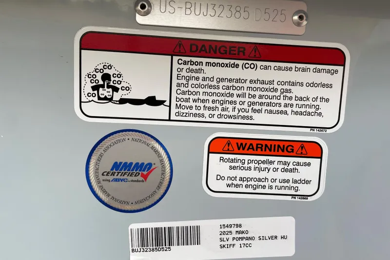 Slide: The Image of 2025 Mako Pro Skiff 17 CC warning labels for carbon monoxide and propeller safety. - 52