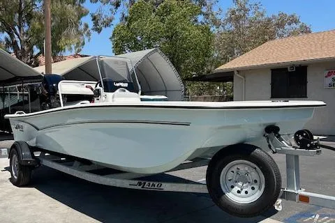 The Image of 2025 Mako Pro Skiff 17 CC boat on trailer, side view, outdoors. - 0