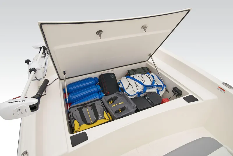 Slide: The Image of 2025 Mako Pro Skiff 17 CC boat interior with storage compartment and seating. - 10