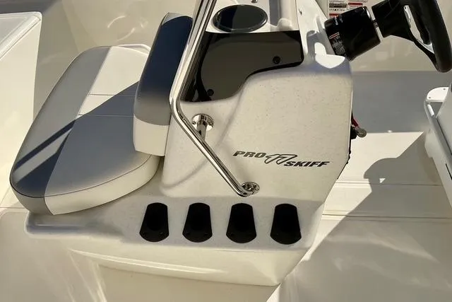 Slide: The Image of 2025 Mako Pro Skiff 17 CC boat console with seating and steering wheel. - 12